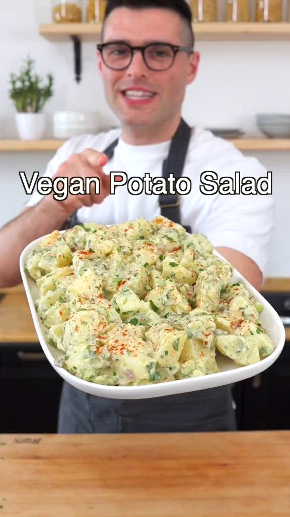 This contains: A delectable vegan potato salad recipe featuring a colorful mix of fresh vegetables and creamy plant-based dressing, perfect for picnics and gatherings. #VeganPotatoSalad #PlantBasedEats #HealthyPicnicFood #CrueltyFreeDelight #VeganSideDish #PlantPoweredSalad #DairyFreeRecipe #FreshAndFlavorful