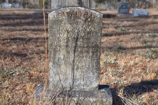 A weathered gravestone marking the burial site of Leasan Ray, who died on June 29, 1915, at the age of 75 years.