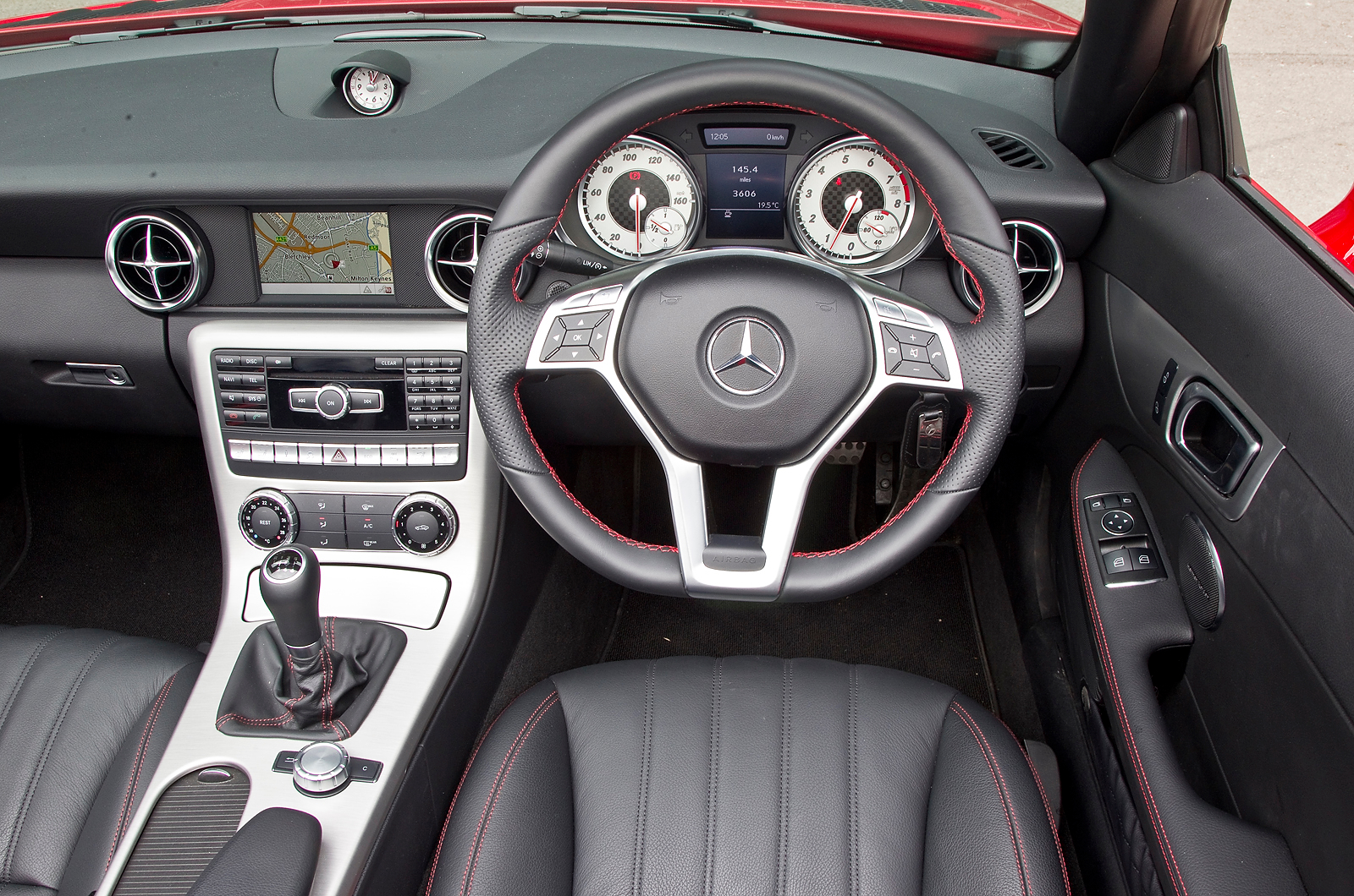The cockpit is full of brushed aluminium switches and vents which show Mercedes premium status Mercedes-Benz SLK dashboard