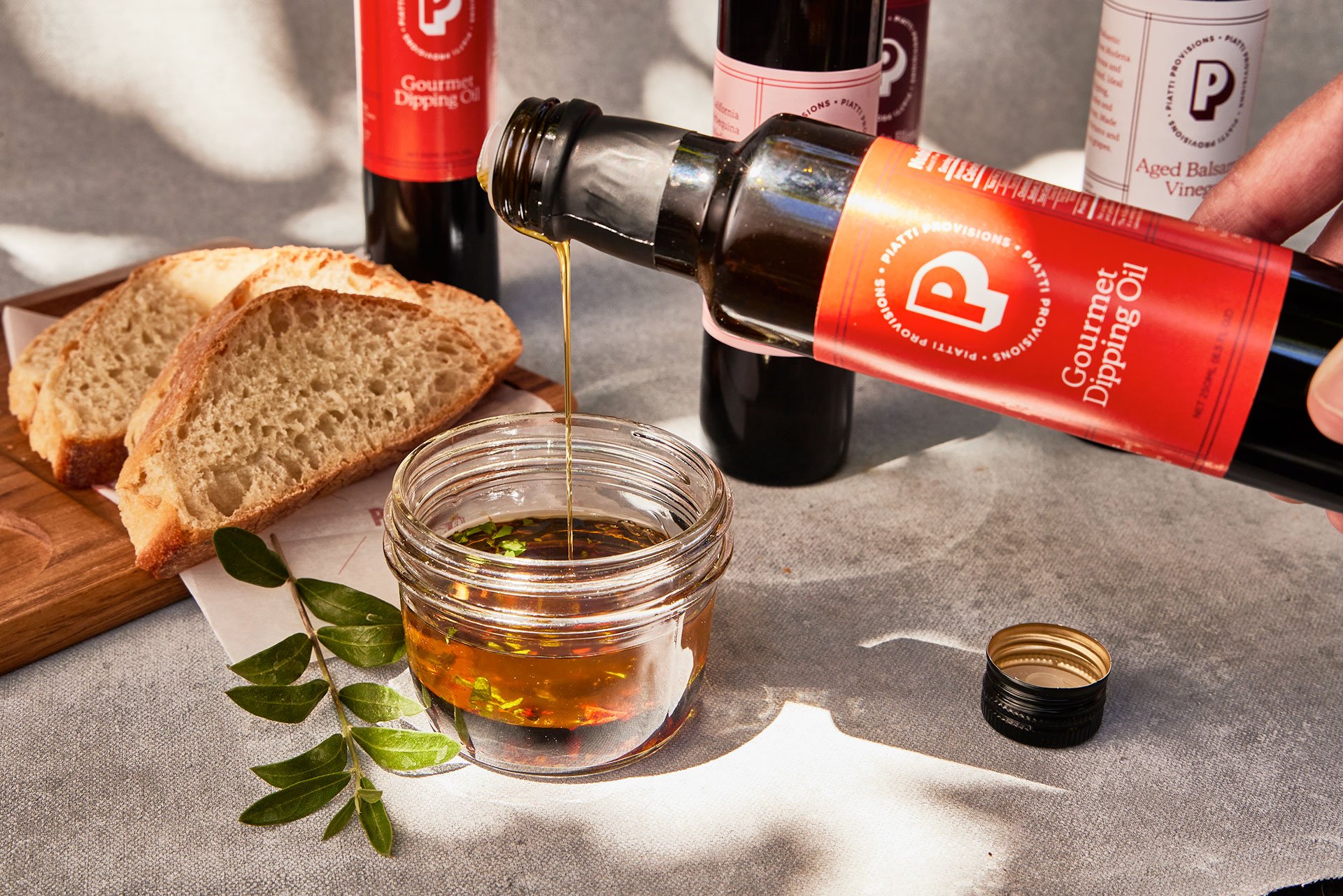 Piatti Provisions dipping oil being poured into a jar