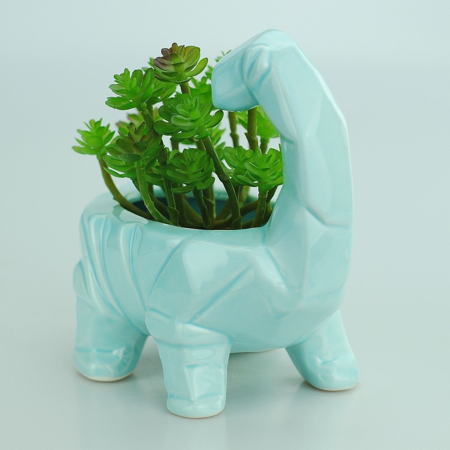 blue ceramic dinosaur planter