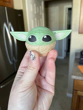 hand holding up the speaker