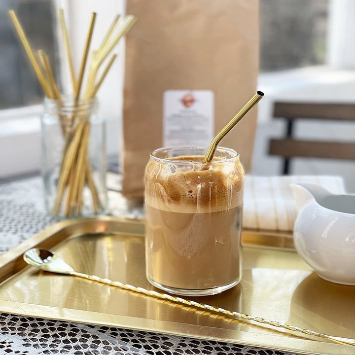 gold reusable straw in mason jar with frothed iced coffee