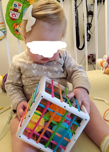 Reviewer's child playing with the bin and shapes