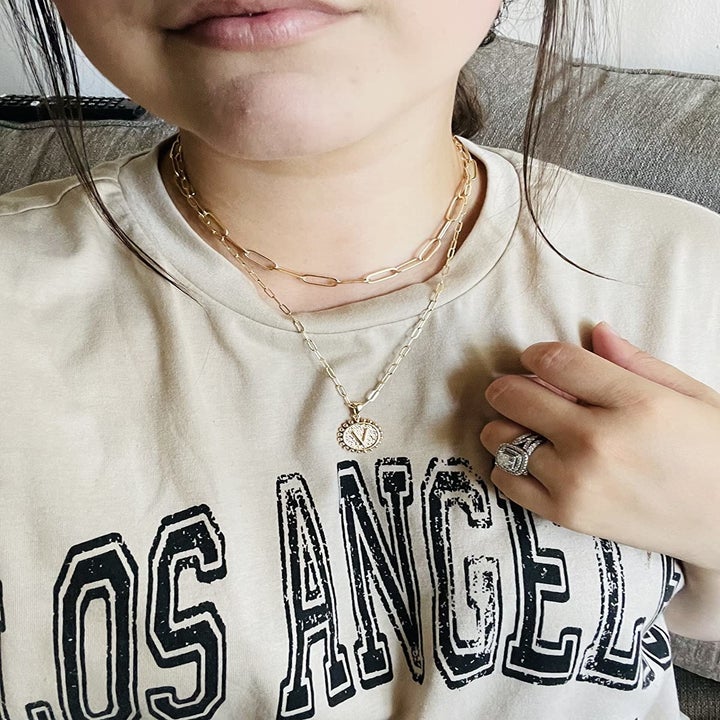 reviewer wears same necklace set with the letter "v"
