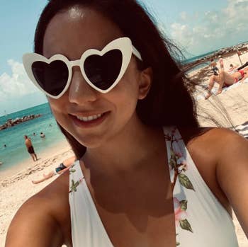 reviewer in the white heart shaped sunglasses at the beach