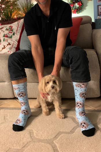 a reviewer wearing the socks with their dog's face on them