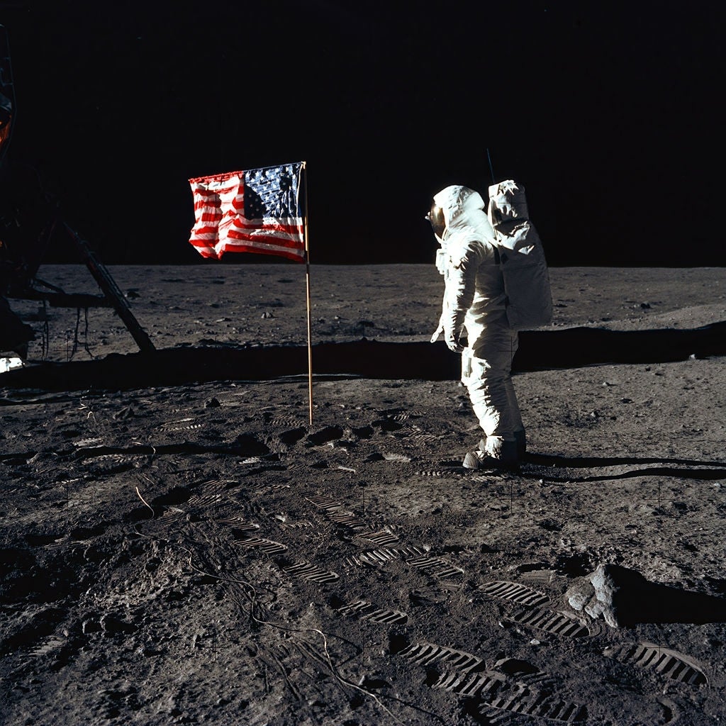 Astronaut in a spacesuit stands on the moon near a flag. Lunar surface and lander visible. Iconic historic moment