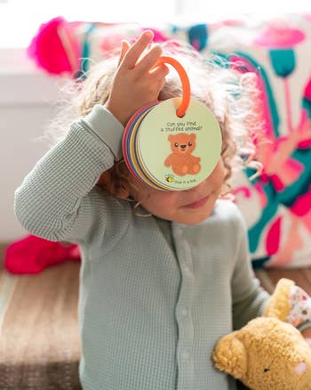 a model child holding the scavenger hunt with a page that says