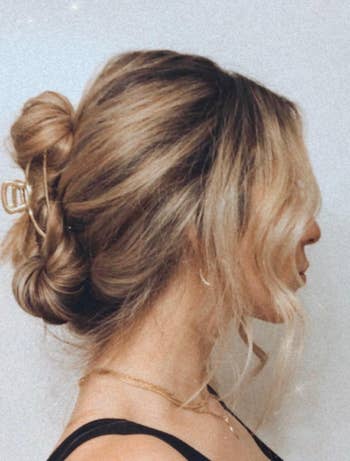 reviewer with styled hair pulled into the gold claw clip at the back