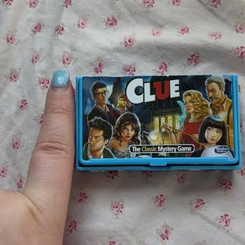mini version of clue with a finger for scale