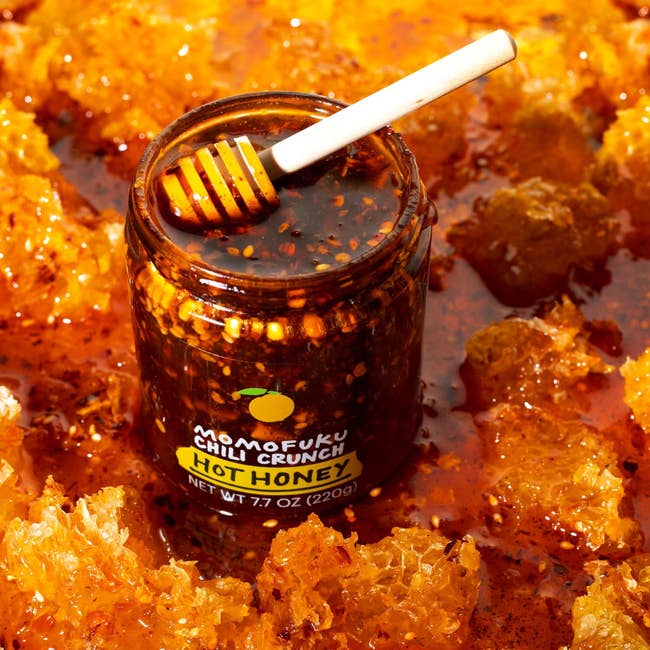 Jar of Momofuku Chili Crunch Hot Honey with honeycomb pieces surrounding it