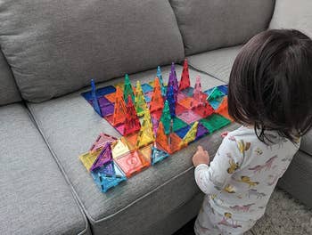 a reviewer's child playing with the colorful tiles