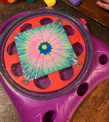 a splatter painting made of pink, green, yellow, and blue