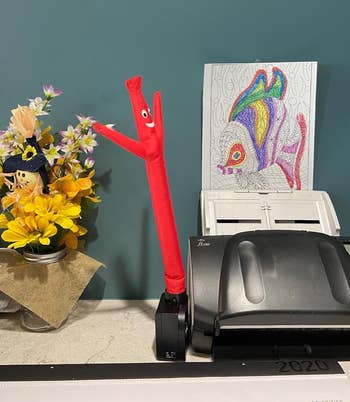 the inflatable tube guy on a desk