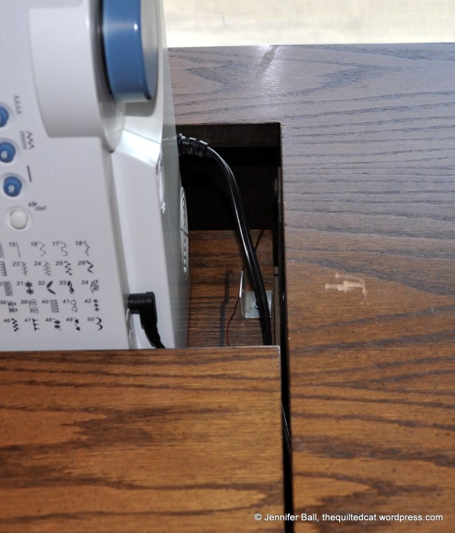 A few small scratches on the sewing cabinet surface