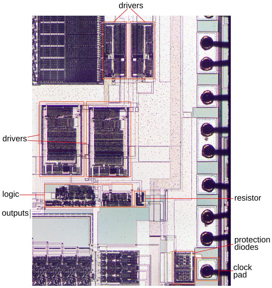 Details of the clock circuitry. This image shows the two metal layers. At the right, bond wires are connected to the pads on the die. Details of the clock circuitry. This image shows the two metal layers. At the right, bond wires are connected to the pads on the die.