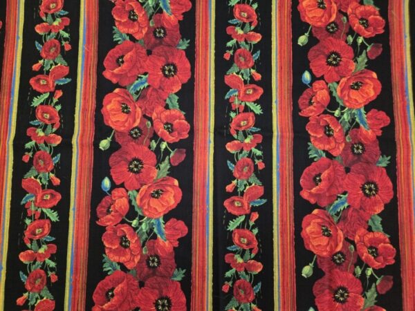 Red poppy flowers with green leaves on black and red striped fabric.