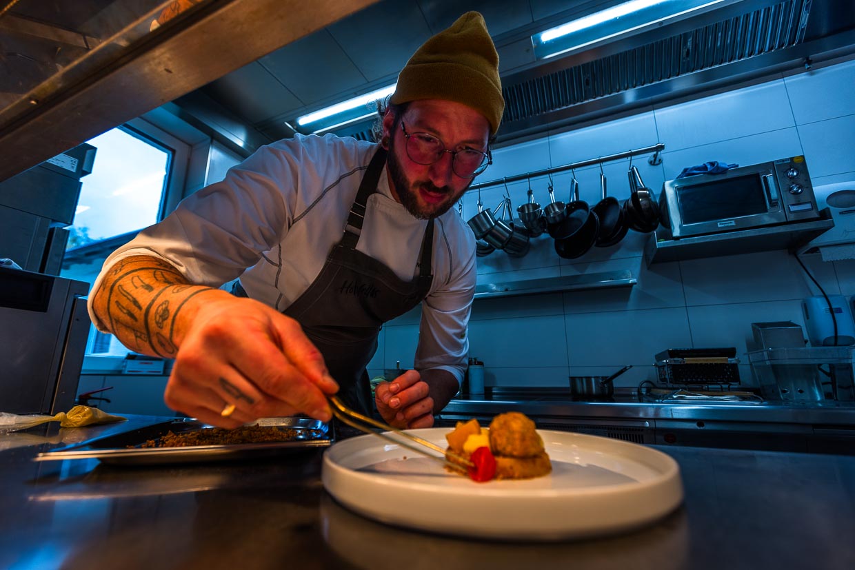 Chefkoch Ingo Mark beim Anrichten eines Gerichts mit Karpfenfilet und Kürbis / © Foto: Georg Berg