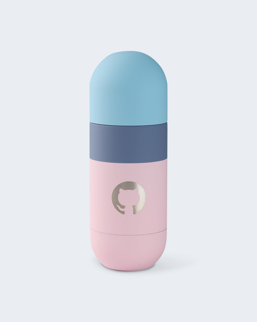 Color-blocked tumbler in pastel blue, navy, and pink with a metallic GitHub logo on the front.