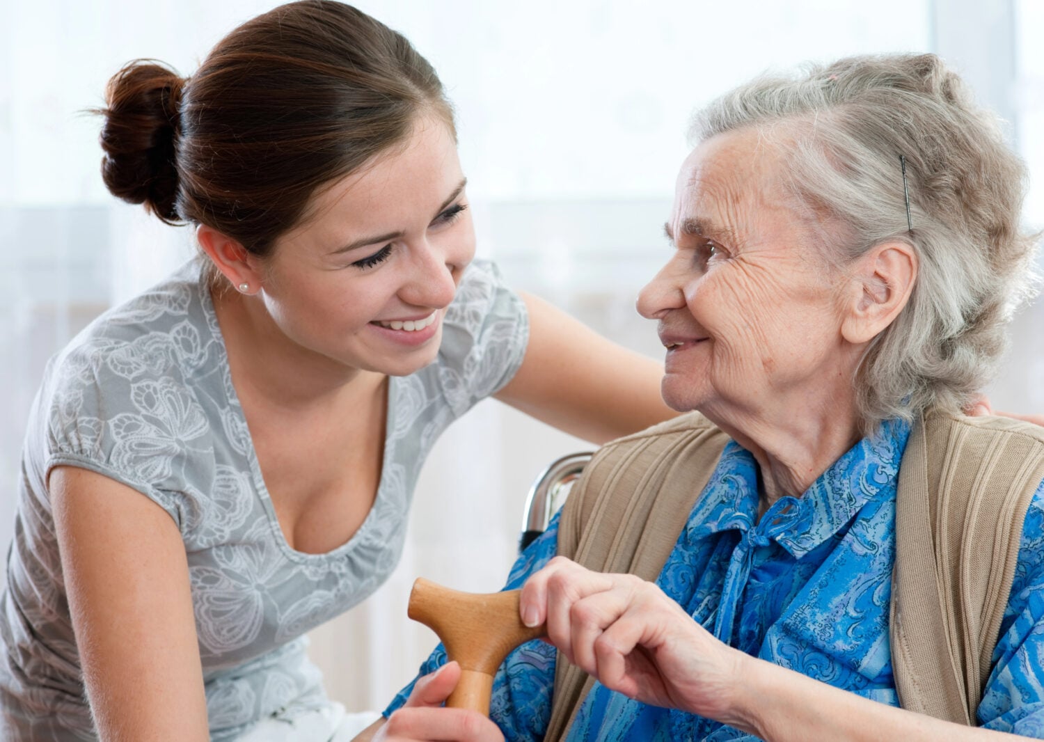 young woman caring for an elderly lady