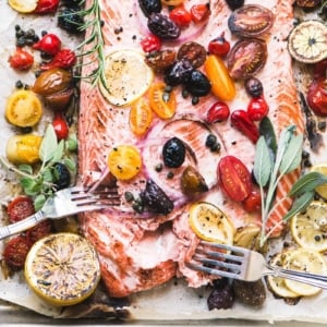Mediterranean roasted sheet pan salmon with tomatoes, olives, onion, and lemon