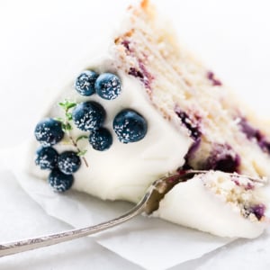 a slice of blueberry lemon layer cake with fork