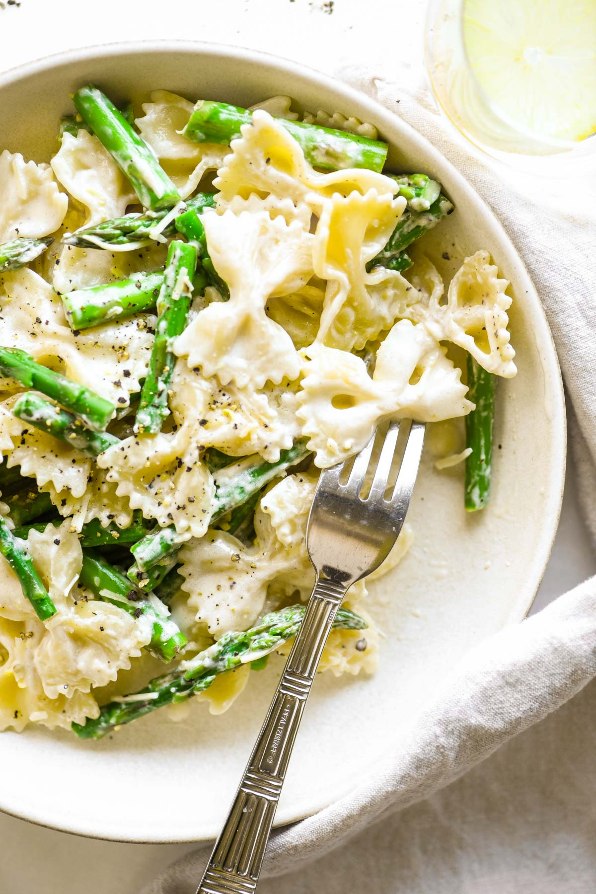 creamy lemon asparagus pasta on a plate with fork