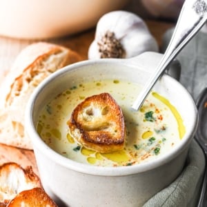 Country French Garlic Soup in a mug with croutons.