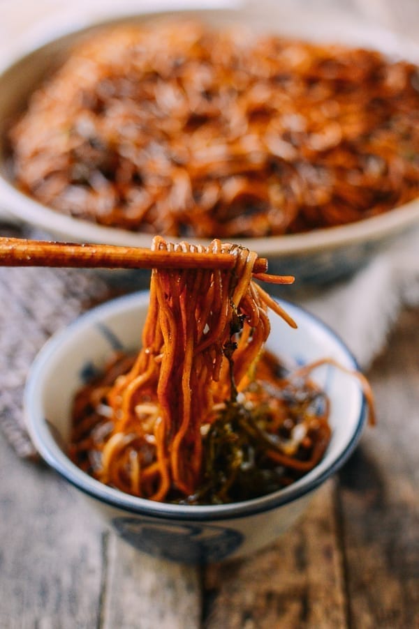 Picking up scallion oil noodles with chopsticks, thewoksoflife.com