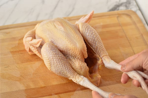 whole buddhist style chicken on cuttting board
