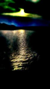 Abstract image of sunrise over the rippled sruface of a lake.