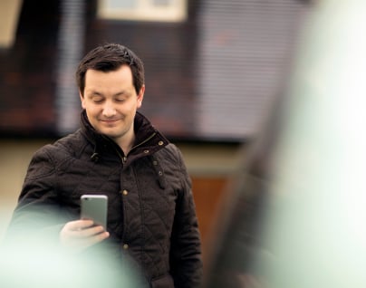 Competitive advertising rates A customer viewing their advertised vehicles on a smartphone via Autotrader