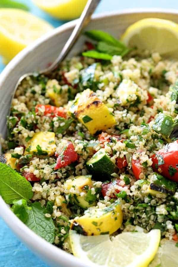 Close-up photo of Quinoa Tabbouleh with Grilled Vegetables in a white bowl.