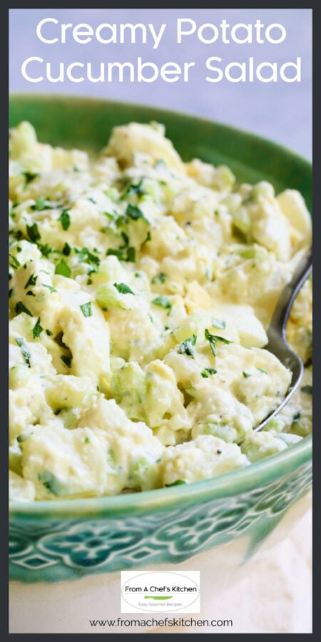 Creamy Potato Cucumber Salad in green bowl with serving spoon.