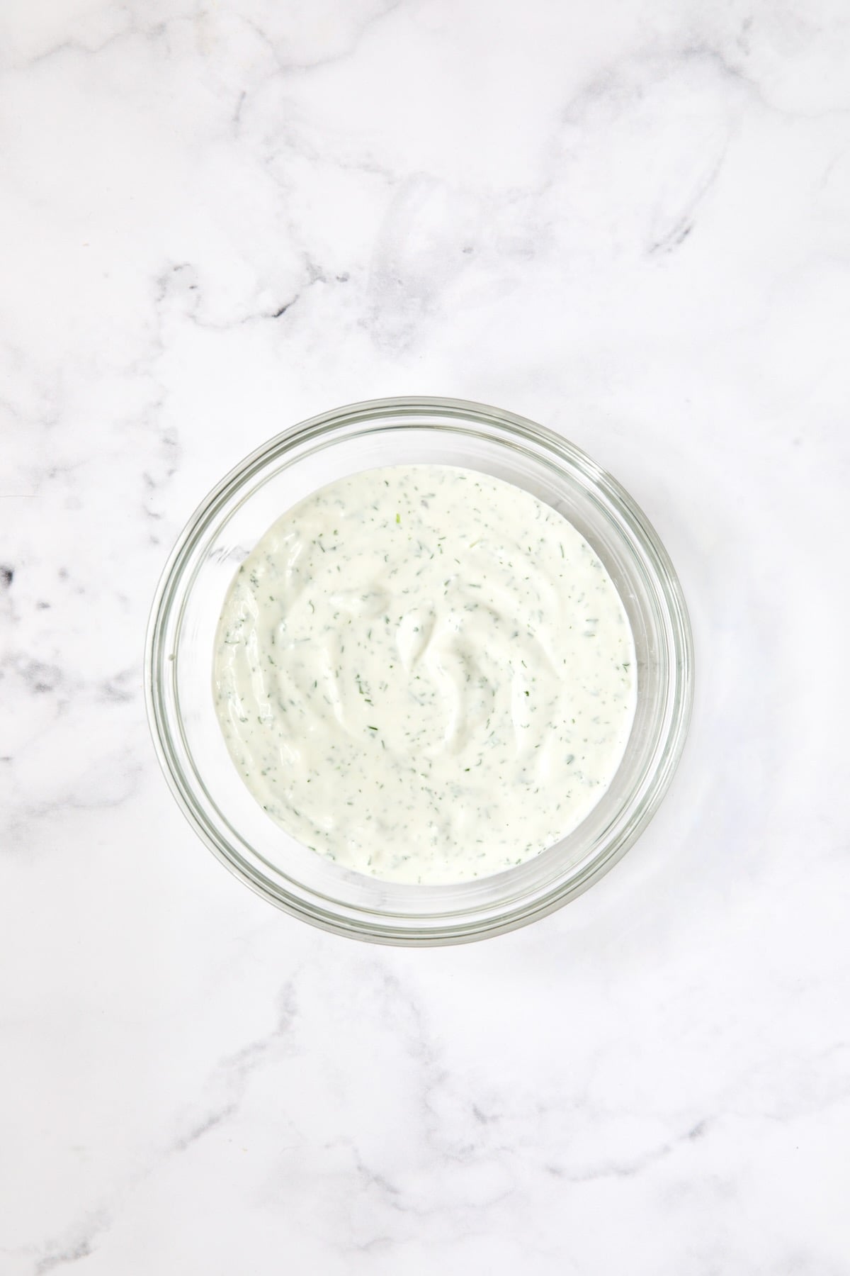 Salad dressing in glass bowl.