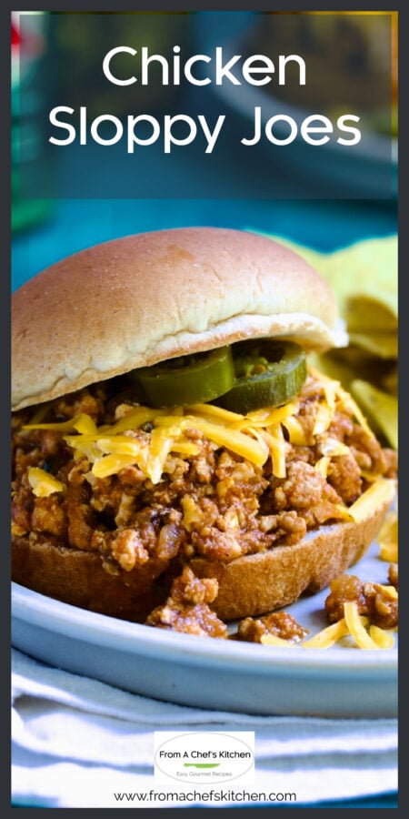 Chicken Sloppy Joes with grated cheddar cheese and jalapeno slices on top.