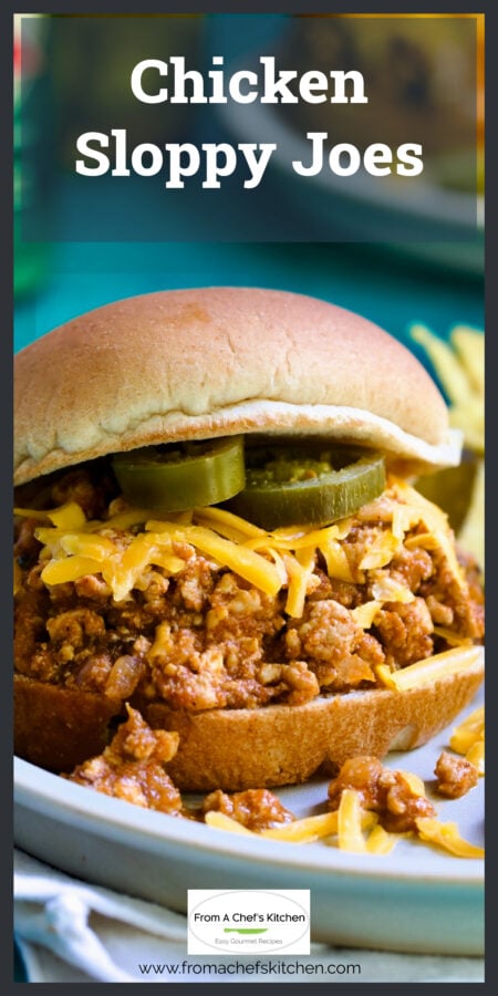 Chicken Sloppy Joes with grated cheddar cheese and jalapeno slices on top.