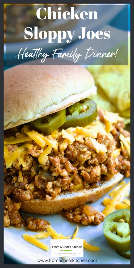 Chicken Sloppy Joes with grated cheddar cheese and jalapeno slices on top.