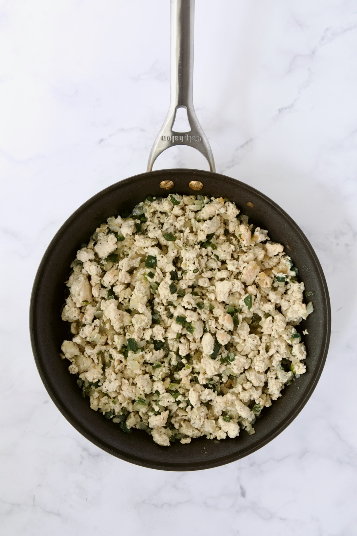Cooked ground chicken, onions and poblano peppers in nonstick skillet.