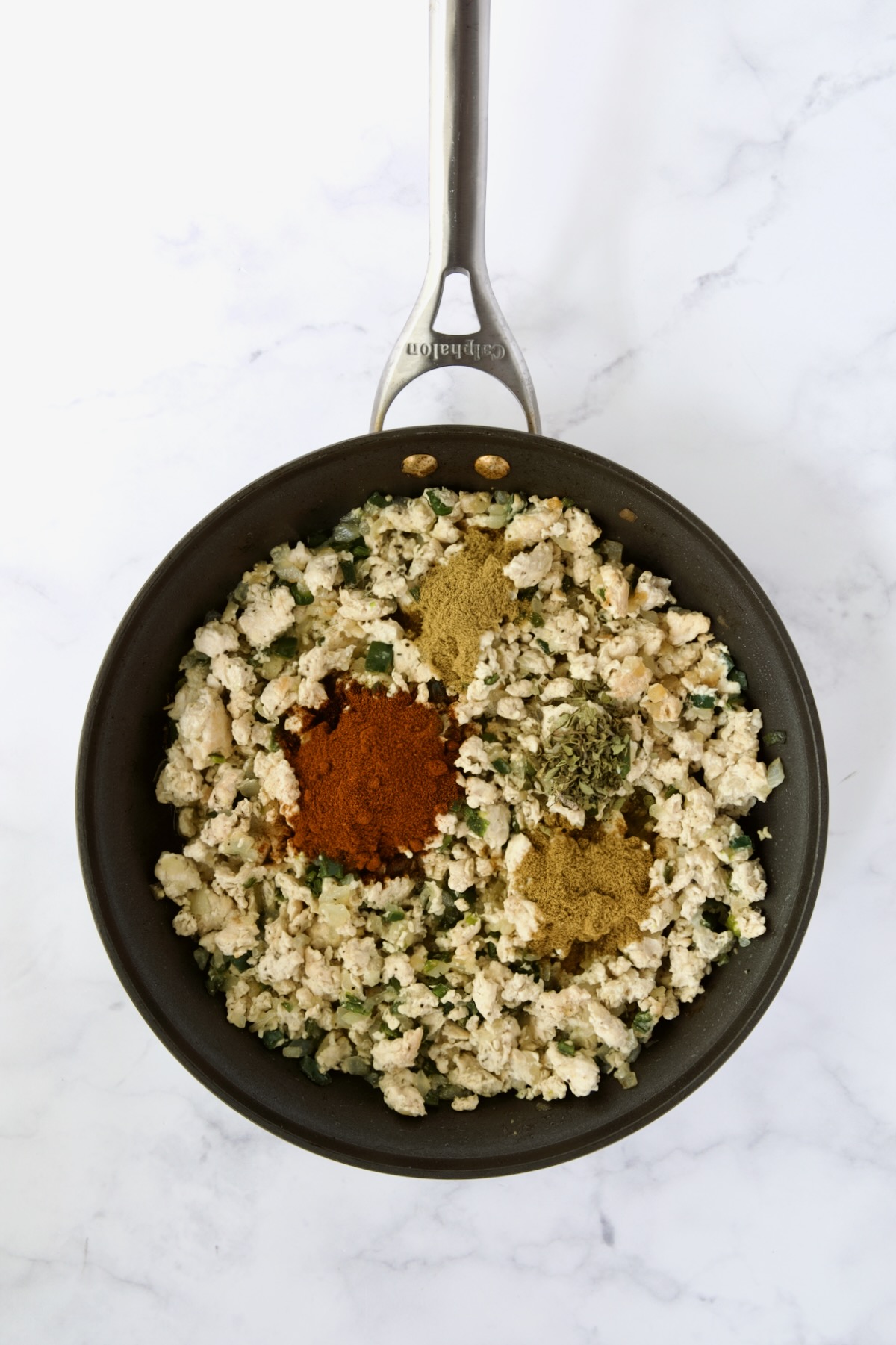 Cooked ground chicken, onions and poblanos with chili powder, cumin, coriander and oregano added in nonstick skillet.