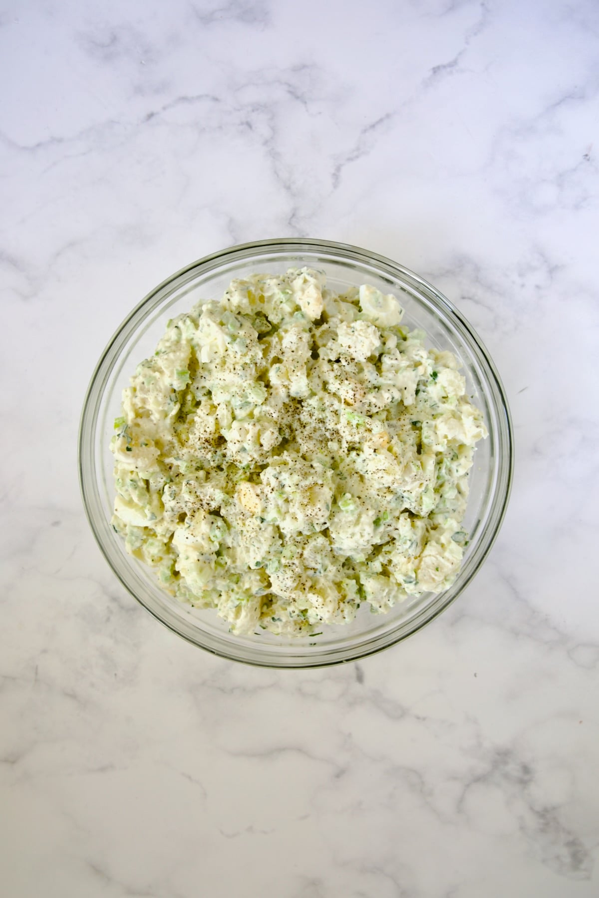 Creamy Potato Cucumber Salad in glass bowl.