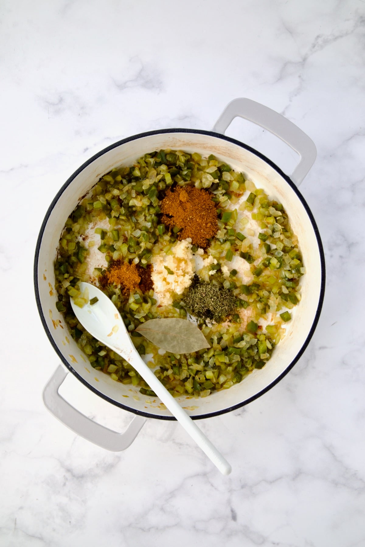 Cooked onions, celery and green bell pepper with Cajun seasoning, cayenne, thyme, garlic and bay leaf added.