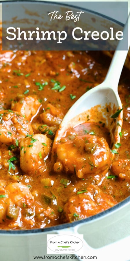 Pinterest graphic for The Best Shrimp Creole showing a white spoon scooping up a piece of shrimp from a white enamel cast iron skillet.