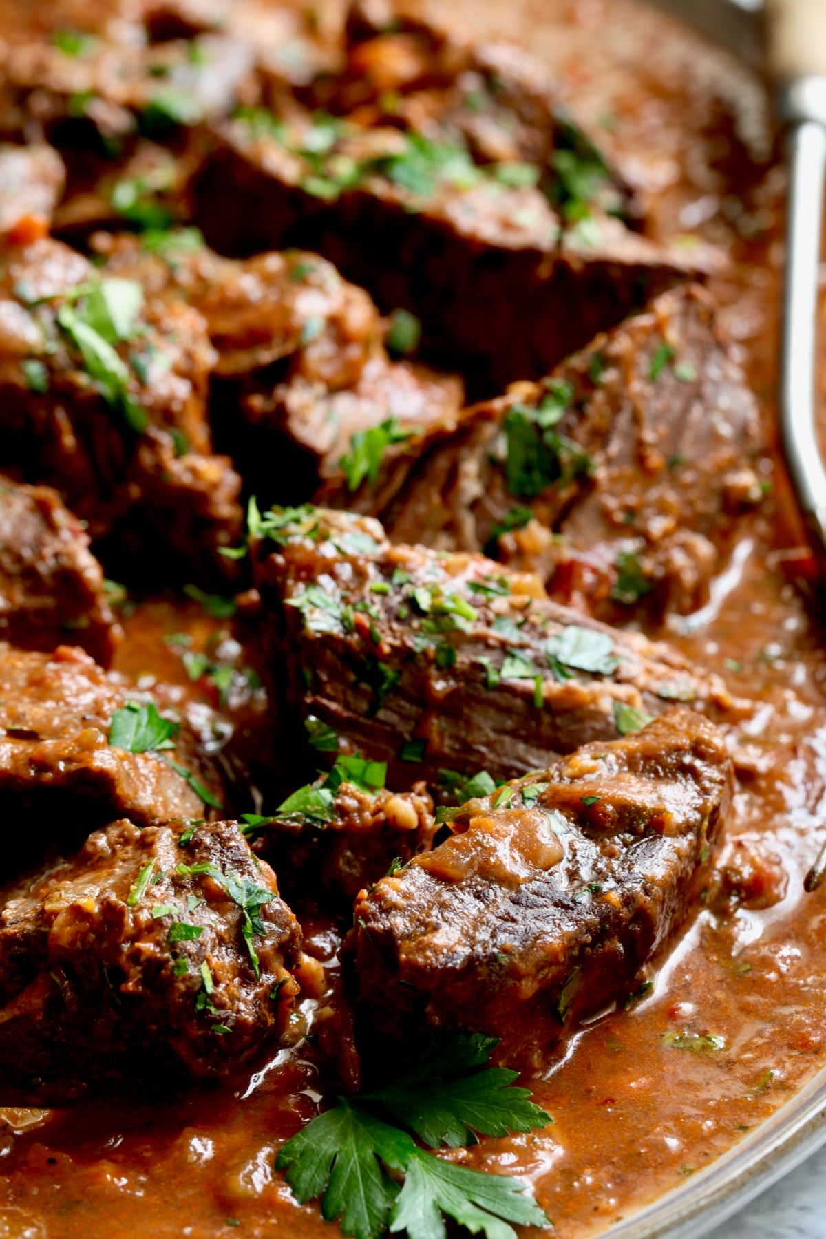 Italian Pot Roast (Stracotto) on platter with serving fork.