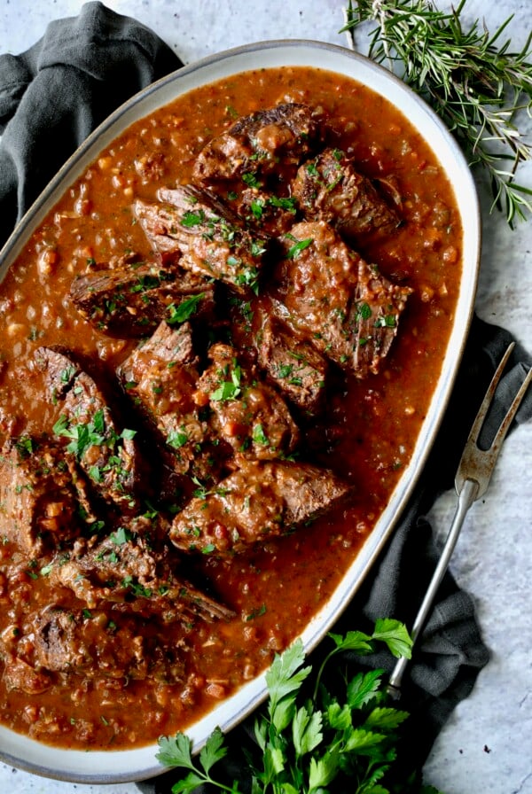 Italian Pot Roast (Stracotto) on gray-rimmed platter.