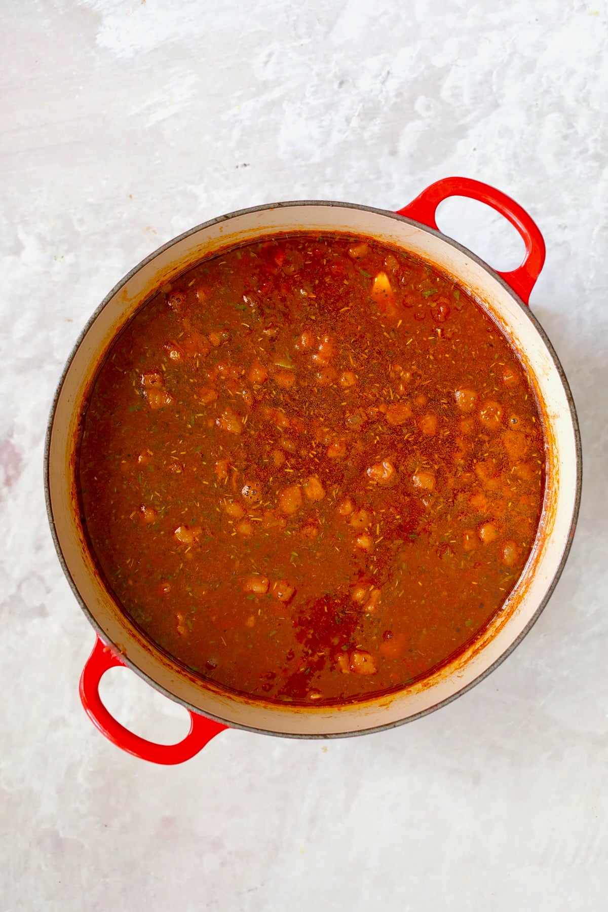All ingredients for Italian Pot Roast (Stracotto) in red enamel cast iron Dutch oven before going into the oven.