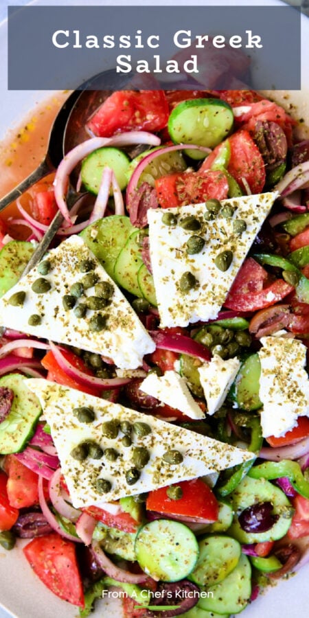 Pinterest graphic for Classic Greek Salad showing it on an oval white platter.