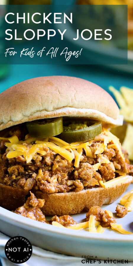 Pinterest graphic for Chicken Sloppy Joes showing one serving on a plate garnished with shredded cheese and jalapeno cheese slices.