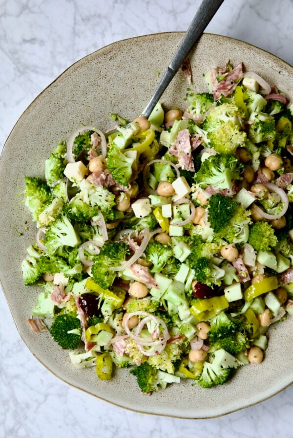 Italian Broccoli Salad in earthenware bowl with serving fork.